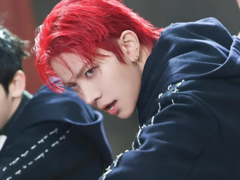 Heeseung performing on stage with K‑pop group ENHYPEN.